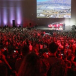 Excited employees gather to witness the first Model 3's being delivered.