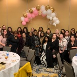 Associates gather to celebrate a co-worker's baby shower.